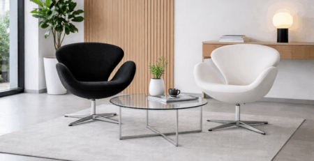 Sala d’attesa moderna con poltrona nera e bianca stile Bauhaus, tavolo in vetro e atmosfera luminosa.